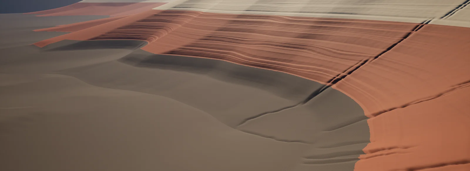 Red and pale rock across a broad slope